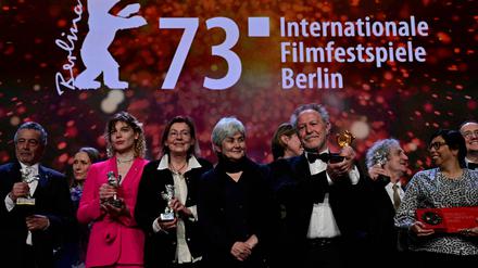 French director Nicolas Philibert poses with the "Golden Bear for Best Film" in front of other laureates after the award ceremony of the 73rd Berlinale International Film Festival in Berlin, on February 25, 2023. (Photo by John MACDOUGALL / AFP)