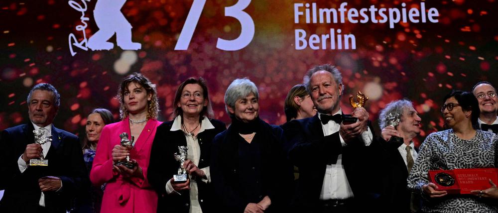French director Nicolas Philibert poses with the "Golden Bear for Best Film" in front of other laureates after the award ceremony of the 73rd Berlinale International Film Festival in Berlin, on February 25, 2023. (Photo by John MACDOUGALL / AFP)
