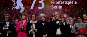 French director Nicolas Philibert poses with the "Golden Bear for Best Film" in front of other laureates after the award ceremony of the 73rd Berlinale International Film Festival in Berlin, on February 25, 2023. (Photo by John MACDOUGALL / AFP)