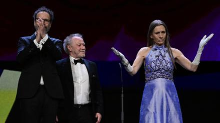(L-R) Berlinale Artistic Director Carlo Chatrian, French director Nicolas Philibert and Berlinale Executive Director Mariette Rissenbeek are seen on stage during the award ceremony of the 73rd Berlinale International Film Festival in Berlin, on February 25, 2023. (Photo by John MACDOUGALL / AFP)
