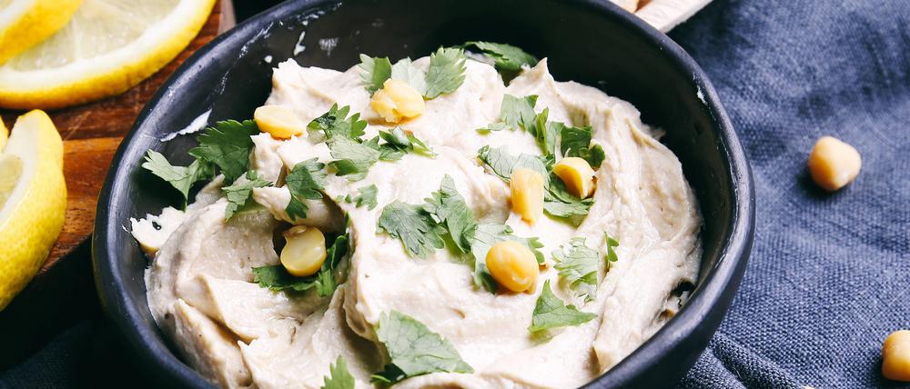 Delicious hummus on the table , 15849062.jpg, hummus, food, bowl, snack, appetizer, vegan, vegetable, cuisine, chickpea, creamy, fresh, paste, delicious, olive, dip, oil, arabic, white, dipping, background, healthy, tahini, traditional, meal, arabian, lunch, levantine, spread, natural, nutrition, close-up, texture, cooking, eating, eat, kitchen, breakfast, dinner, parsley, greens, table, rural, rustic, blue, tablecloth, lemon, dish, bread, tray, wooden,
