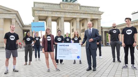 Armut beenden, Gerechtigkeit schaffen: Maxi Köhler präsentiert im Sommer 2022 die von Olaf Scholz unterzeichnete Selbstverpflichtung.