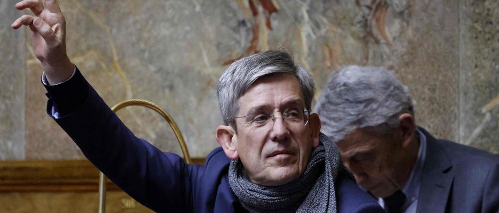 (FILES) In this file photo taken on February 16, 2023, member of the center-right "Libertes, Independants, Outre-mer et Territoires" parliamentary group Charles de Courson raises his hands as he attends to a session to discuss the government's pensions reform plan at the National Assembly, in Paris. - The centrist Charles de Courson, has become at age 70 a fierce opponent of the pensions reform, manoeuvring to attempt to censure the government. (Photo by Ludovic MARIN / AFP)
