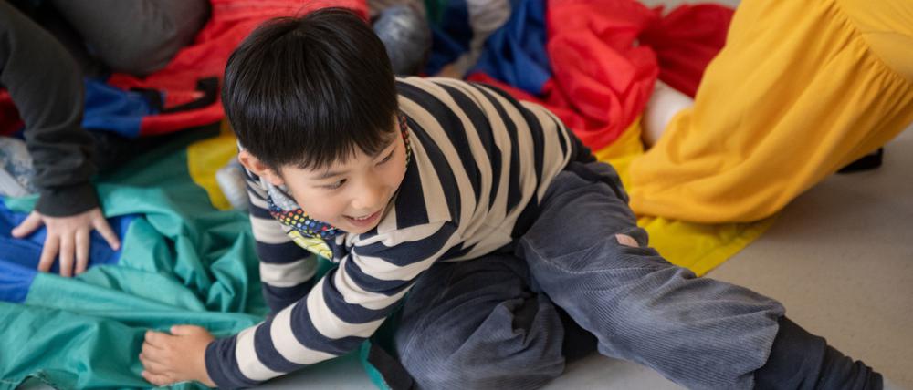 13.03.2023, Baden-Württemberg, Kornwestheim: Kinder einer Kindergartengruppe der Kita Hoppsala nehmen in einem Gruppenraum an einer Bewegungseinheit teil. Seit Sommer 2020 gibt es für Kitas die Möglichkeit, Inhouse-Fortbildungen zur Bewegungsförderung, finanziert durch das Kultusministerium und organisiert durch die Kinderturnstiftung Baden-Württemberg, zu buchen. Dieses Angebot soll nun mit Unterstützung der Unfallkasse Baden-Württemberg vertieft werden. Foto: Marijan Murat/dpa - ACHTUNG: Nur zur redaktionellen Verwendung im Zusammenhang mit der aktuellen Berichterstattung und nur mit vollständiger Nennung des vorstehenden Credits +++ dpa-Bildfunk +++