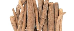 Ginseng ashwagandha herb root and korean powder over bamboo background.