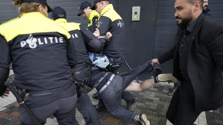 Ein Demonstrant wird von Polizisten festgehalten, als der französische Präsident Macron und der niederländische König Willem-Alexander an der naturwissenschaftlichen Fakultät der Universität von Amsterdam (UvA) eintreffen. 