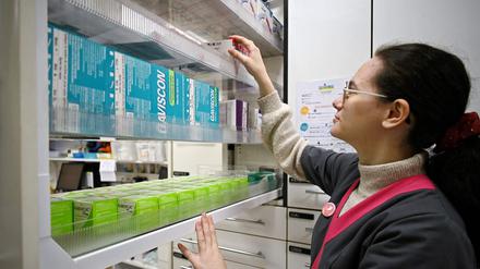 A pharmacy worker opens a drawer full of drugs in a pharmacy in Colomiers, southwestern France, on March 23, 2023. (Photo by Valentine CHAPUIS / AFP)