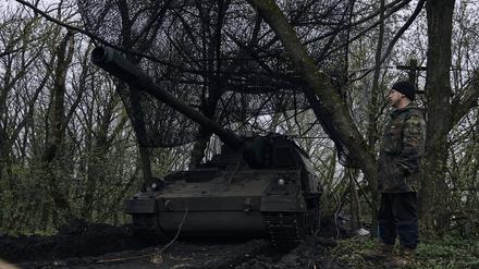 Ein ukrainischer Soldat steht neben einer deutschen Panzerhaubitze 2000, ein selbstfahrendes gepanzertes Artilleriegeschütz, in seiner Stellung an der Frontlinie..
