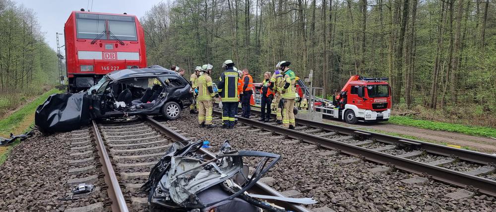 Ein Autowrack liegt auf den Gleisen. 
