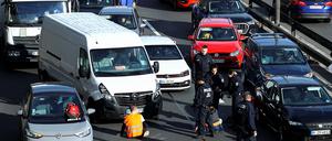 An ambulance is stuck in traffic jam as activists of the "Letzte Generation" (Last Generation) block a highway to protest for climate councils, speed limit on highways as well as for affordable public transport, in Berlin, Germany, April 24, 2023. REUTERS/Christian Mang