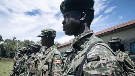 Ugandan soldiers of the East African Community Regional Force (EACRF) stand in formation in Bunagana, Democratic Republic of Congo, on April 19, 2023. - An East African force set up to thwart insurgents in Democratic Republic of Congo has for months been proclaiming progress, saying the rebels have quit key strongholds and been replaced by its troops. But these upbeat announcements contrast with the situation on the ground, where the rebels remain at large and more than a million people displaced by their advance are still in limbo. (Photo by Glody MURHABAZI / AFP)