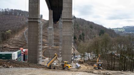 Arbeiter und Baustellenfahrzeuge unter der Rahmede-Talbrücke der Autobahn 45.