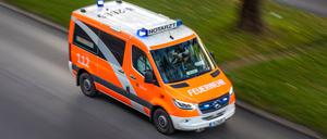 Rettungswagen der Feuerwehr mit Blaulicht auf Einsatzfahrt. 