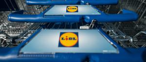 Einkaufswagen stehen vor einer Filiale des Lebensmitteldiscounters Lidl.