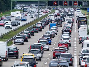 ARCHIV - 11.09.2022, Bayern, Sauerlach: Autos und Reisebusse stehen auf der Autobahn 8 in Richtung Norden im Stau.  Um den Verkehr zumindest ein wenig zu entlasten, gelte am Feiertag ein Fahrverbot für Brummis über 7,5 Tonnen, wie ein Sprecher des ADAC in München sagte. (zu dpa: «ADAC: Volle Straßen zum ersten Maiwochenende erwartet») Foto: Peter Kneffel/dpa +++ dpa-Bildfunk +++