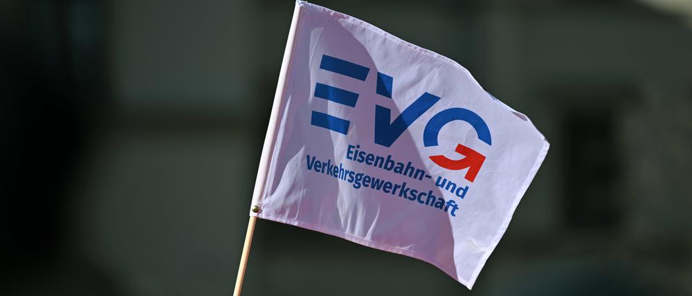 Ein Teilnehmer am Warnstreik vor dem Erfurter Hauptbahnhof schwenkt ein Fähnchen der Eisenbahn- und Verkehrsgewerkschaft EVG (Symbolbild).