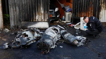 Police officer inspects remains of a Russian cruise missile shot down by Air Defence Forces, amid Russia's attack on Ukraine, in Kyiv, Ukraine May 18, 2023. REUTERS/Valentyn Ogirenko