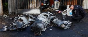 Police officer inspects remains of a Russian cruise missile shot down by Air Defence Forces, amid Russia's attack on Ukraine, in Kyiv, Ukraine May 18, 2023. REUTERS/Valentyn Ogirenko