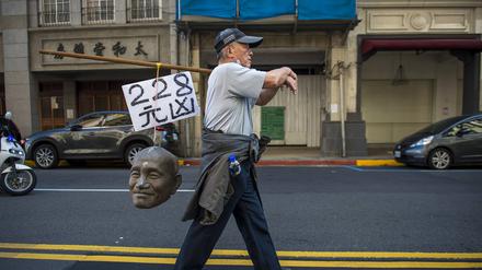 Ein Demonstrant erinnert in Taipeh an das 228-Massaker, bei dem die KMT 1947 bis zu 28.000 Taiwanesen tötete. Auf dem Schild über dem Chiang-Schädel steht „Haupttäter“.