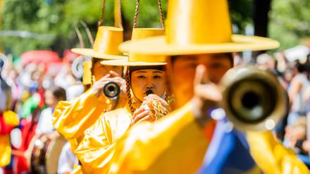28.05.2023, Berlin: Darsteller einer koreanischen Gruppe treten beim Umzug des Karnevals der Kulturen in Berlin-Kreuzberg auf. Nach dreimaliger pandemiebedingter Absage findet das Straßenfest wieder statt und erreicht mit dem Umzug seinen Höhepunkt. Foto: Christoph Soeder/dpa +++ dpa-Bildfunk +++