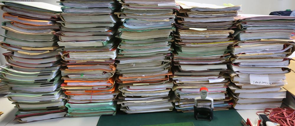 ARCHIV - 14.01.2014, Berlin: SYMBOLFOTO - Stapel mit Akten liegen auf einem Schreibtisch. (zu dpa «Bundeskabinett beschließt Maßnahmenpaket zum Bürokratieabbau» vom 12.12.2018) Foto: Stephanie Pilick/dpa +++ dpa-Bildfunk +++ | Verwendung weltweit