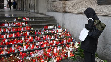 A place of worship with candles is seen in front of the Faculty of Arts, Charles University. 