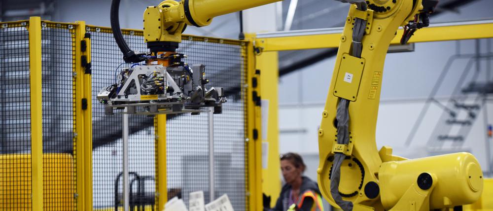 A robot prepares to pick up a tote containing product during the first public tour of the newest Amazon Robotics fulfillment center on April 12, 2019 in the Lake Nona community of Orlando, Florida. The over 855,000 square foot facility opened on August 26, 2018 and employs more than 1500 full-time associates who pick, pack, and ship customer orders with the assistance of hundreds of robots which can lift as much as 750 pounds and drive 5 feet per second. (Photo by Paul Hennessy/NurPhoto via Getty Images)