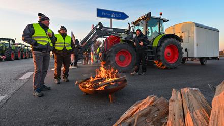 Landwirte blockieren am frühen Morgen im brandenburgischen Jacobsdorf mit einem Traktor die Auffahrt auf die Autobahn A12 in Richtung Berlin.
