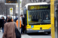 Passanten steigen in Berlin in einen Bus.