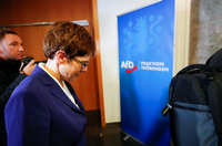 Annegret Kramp-Karrenbauer, chairwoman of Germany&apos;s conservative Christian Democratic Union party CDU walks past a sign of Germany&apos;s far-right Alternative for Germany (AFD) party following a meeting at the federal parliament of the state of Thuringia in Erfurt, Germany February 7, 2020. REUTERS/Wolfgang Rattay