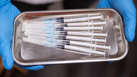 Aufgezogene Spritzen mit Impfstoff gegen Covid-19 liegen in einem Impfzentrum in einer Schale. 