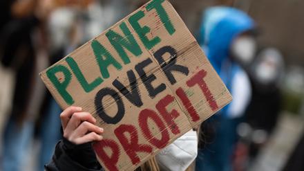 Bei einer Demonstration der Klimaaktivisten Fridays For Future trägt eine Teilnehmerin ein Plakat mit der Aufschrift „Planet over Profit“.