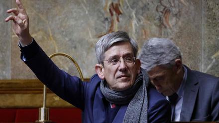(FILES) In this file photo taken on February 16, 2023, member of the center-right "Libertes, Independants, Outre-mer et Territoires" parliamentary group Charles de Courson raises his hands as he attends to a session to discuss the government's pensions reform plan at the National Assembly, in Paris. - The centrist Charles de Courson, has become at age 70 a fierce opponent of the pensions reform, manoeuvring to attempt to censure the government. (Photo by Ludovic MARIN / AFP)