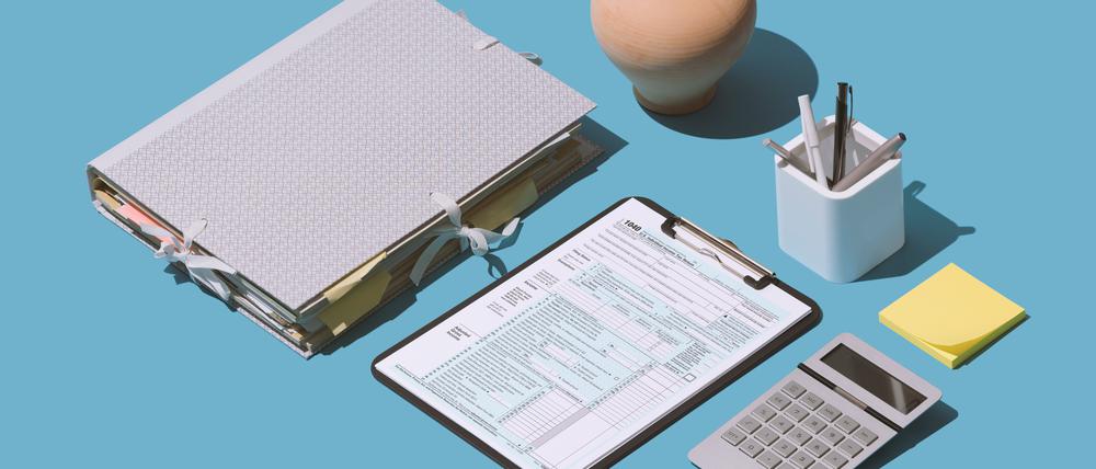 Filing the 1040 individual income tax return form on the office desk, finance and accounting concept, isometric objects