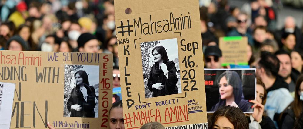 Demonstrierende halten am 28. September 2022 Plakate von Mahsa Amini hoch.