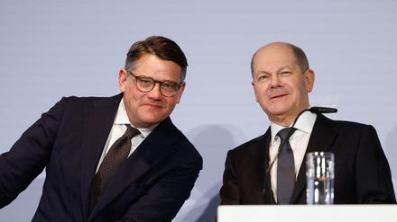 German Chancellor Olaf Scholz (R) and Hesse's State Premier Boris Rhein (L) react during a joint press conference after a meeting with regional leaders on March 6, 2024 in Berlin, to discuss the country's current migration policy. (Photo by Odd ANDERSEN / AFP)