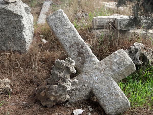 A fallen cross lies in a Protestant cemetery on Mount Zion. 