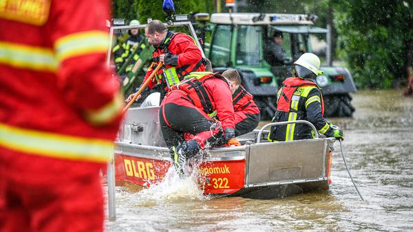 01.06.2024, Bayern, Babenhausen: Angehörige der DLRG aus Memmingen sind dabei, Leute aus überschwemmten Wohnungen  zu evakuieren. Foto: Jason Tschepljakow/dpa +++ dpa-Bildfunk +++