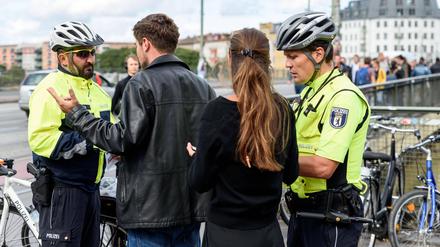 Polizisten der Fahrradstaffel kontrollieren auf der Warschauer Brücke.