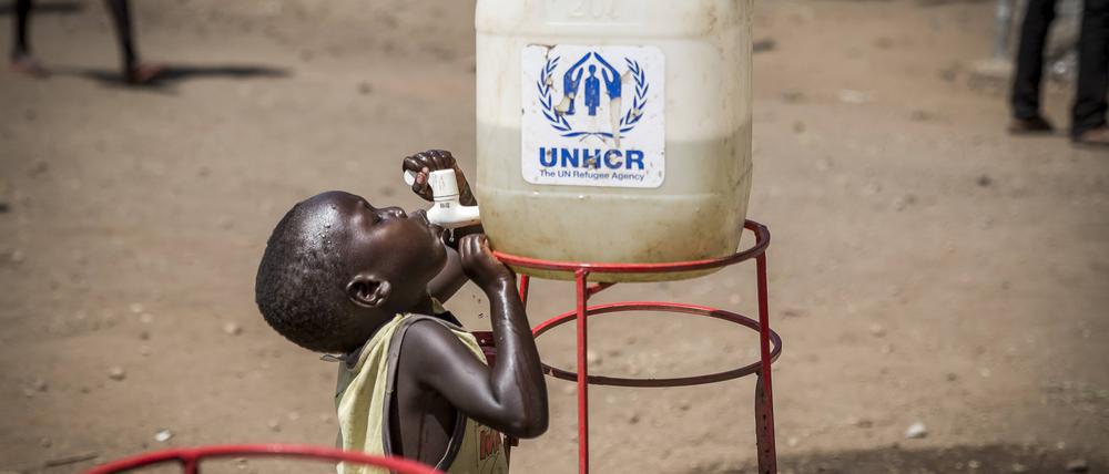 Ein geflüchtetes Kind aus dem Südsudan trinkt am 26. Mai 2017 in Uganda aus einem Wassertank der UNCHR.