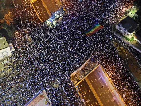 Demonstrators gather in Tel Aviv on March 18, 2023 to protest against judicial reform for the eleventh consecutive week. 