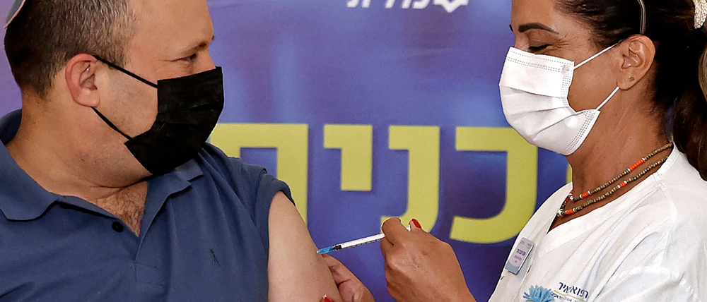 Der isralische Premierminister Naftali Bennett erhält seine dritte Impfung. Foto: Jack Guez/AFP