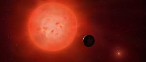 Illustration eines Roten Zwergsterns, umkreist von einem Planeten.