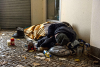 Ein Obdachloser liegt in Berlin in einem Hauseingang.