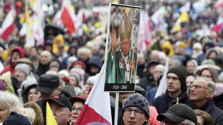 Menschen nehmen an einem Marsch zur Verteidigung des ehemaligen Papstes Johannes Paul II. teil.