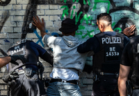September 2019: Berliner Polizeibeamte kontrollieren in einem Park einen Mann mit dunkler Hautfarbe als mutmaßlichen Drogendealer.