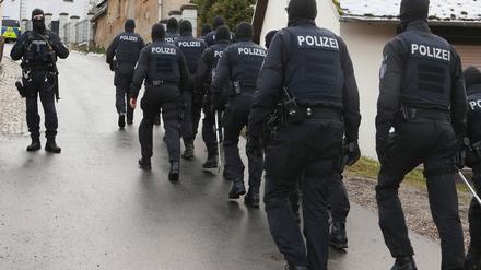 Einsatzkräfte der Polizei laufen zum Jagdschloss Waidmannsheil.