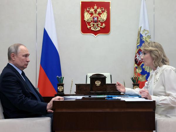 Kremlin chief Vladimir Putin and Russian child rights commissioner Maria Lwova-Belowa.
