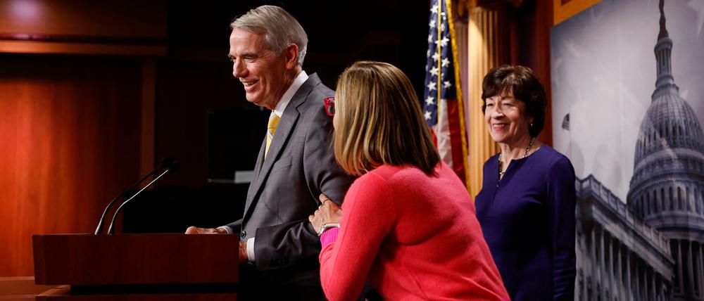 WASHINGTON, DC - NOVEMBER 29: U.S. Sen. Kyrsten Sinema (D-AZ) pats Sen. Rob Portman (R-OH) as Sen. Susan Collins (R-ME) looks on during a news conference after the Senate passed the Marriage Equality Act at the Capitol Building on November 29, 2022 in Washington, DC. In a 61-36 vote, the measure would provide federal recognition and protection for same-sex and interracial marriages.   Anna Moneymaker/Getty Images/AFP (Photo by Anna Moneymaker / GETTY IMAGES NORTH AMERICA / Getty Images via AFP)
