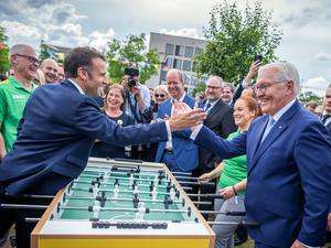 Frankreichs Staatschef Emmanuel Macron (links) und Bundespräsident Frank-Walter Steinmeier zeigten sich am Sonntag beim Bürgerfest an einem Tischkicker. 